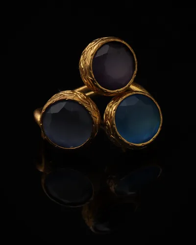 Denim - a gold-plated ring with three blue and navy cat eye stones, on black